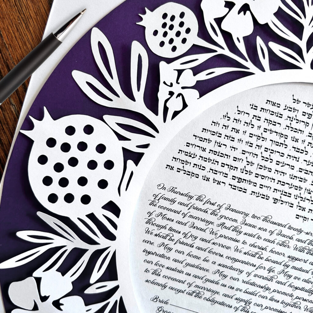 Close up of pomegranate papercut ketubah