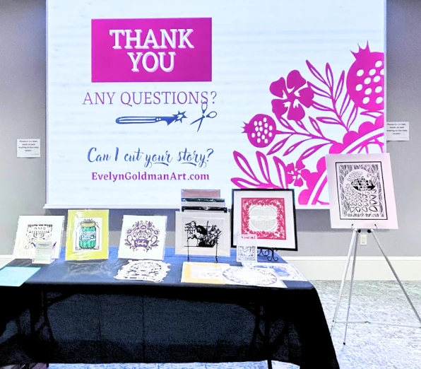 Thank you slide from a presentation, with my papercut art on a table in front of the projected board