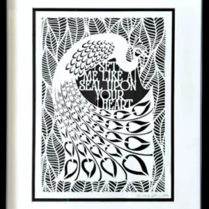 The peacock in the middle of the papercut is surrounded by broad leaves. The English text for the quote sits between the peacock's curved tail and body. By Evelyn Goldman Art