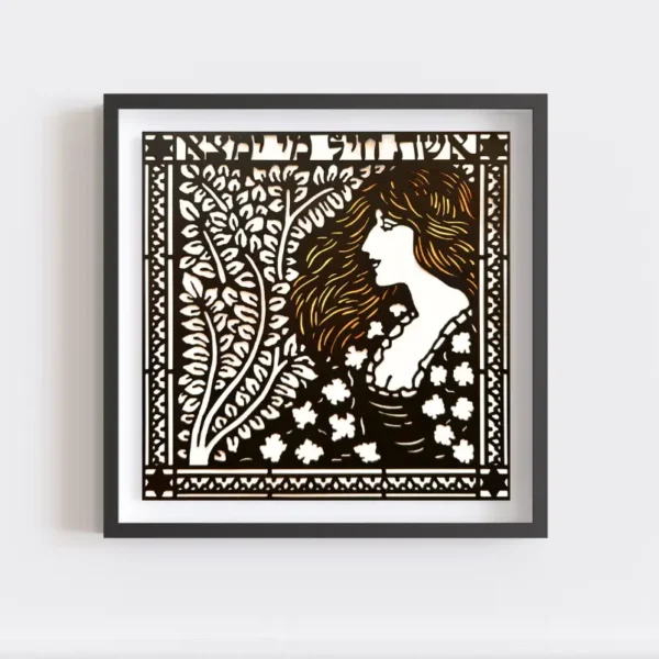 A woman of valor / Eshet Chayil. Framed artwork depicting a stylized woman with long hair surrounded by leaves, rendered in a black and white intricate cut-out pattern, hanging on a white wall. Gold paint embellishes her hair from beneath the papercut