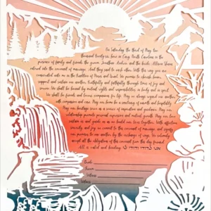 A paper-cut artwork ketubah depicts mountains, trees, a waterfall and river, a pair of boots, a dog, and a tent with a handwritten marriage contract at the center, beneath a sunrise.